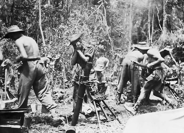 British troops firing a mortar on the Mawchi road. July 1944,