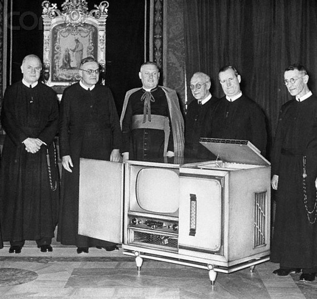 Angello Dell Acqua Inspecting a Television