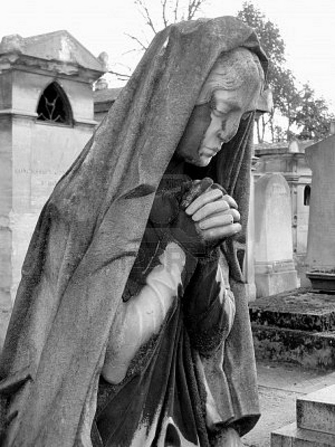 2406669-black-and-white-image-of-a-praying-woman-sculpture-in-parisian-cemetery-of-pere-lachaise