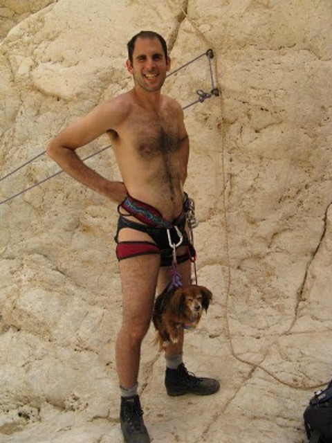 naked mountain climber and dog