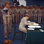 September 2, 1945 Gen. Douglas MacArthur signs the Japanese surrender documents aboard the USS Missouri in Tokyo Bay. Lt. Gen. Jonathan Wainwright, left foreground, who surrendered Bataan to the Japanese, and