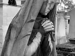 2406669-black-and-white-image-of-a-praying-woman-sculpture-in-parisian-cemetery-of-pere-lachaise