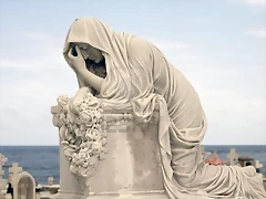 9304209-statue-of-woman-in-mourning-at-a-cemetery