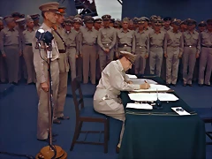 September 2, 1945 Gen. Douglas MacArthur signs the Japanese surrender documents aboard the USS Missouri in Tokyo Bay. Lt. Gen. Jonathan Wainwright, left foreground, who surrendered Bataan to the Japanese, and